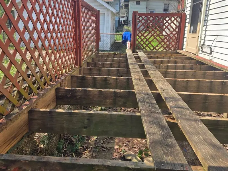 Deck framing repair with joist replacement underway