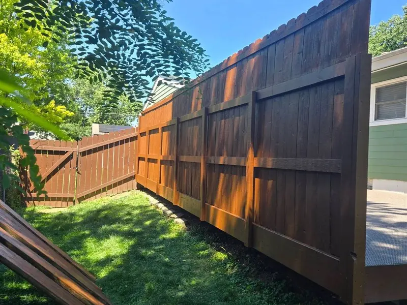 Freshly stained deck and fence after restoration